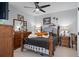 Bedroom with wooden bed, ceiling fan, and a large stuffed dog at 3276 Sea Grape Dr, Hernando Beach, FL 34607