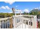 White boat lift with wooden deck overlooking a calm lake at 3276 Sea Grape Dr, Hernando Beach, FL 34607