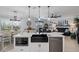 Open kitchen with an island, black farmhouse sink, and white cabinets at 3276 Sea Grape Dr, Hernando Beach, FL 34607