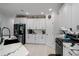 Modern kitchen with white cabinets, marble countertops, and stainless steel appliances at 3276 Sea Grape Dr, Hernando Beach, FL 34607