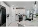 Modern kitchen with white cabinets, marble countertops, and stainless steel appliances at 3276 Sea Grape Dr, Hernando Beach, FL 34607