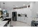 Modern kitchen with white cabinets, quartz countertops, and stainless steel appliances at 3276 Sea Grape Dr, Hernando Beach, FL 34607