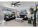 Living room with black reclining sofas and a large ceiling fan at 3276 Sea Grape Dr, Hernando Beach, FL 34607