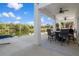 Covered patio with outdoor dining set and canal view at 3276 Sea Grape Dr, Hernando Beach, FL 34607