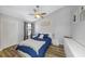 Cozy bedroom with blue bedding, ceiling fan and modern decor at 4239 Brentwood Park Cir, Tampa, FL 33624