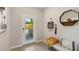 Bright and airy entryway with tiled floors and a modern bench at 5039 Captain Davis Dr, Wimauma, FL 33598