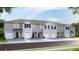 Modern townhome community with attached garages and neutral color palettes at 5039 Captain Davis Dr, Wimauma, FL 33598