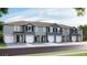 Modern townhouses with attached garages and neutral color palettes at 5054 Captain Davis Dr, Wimauma, FL 33598