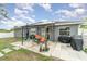 Fenced backyard with patio, grill, and solar panels at 5956 Nyberg Rd, North Port, FL 34291