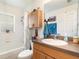 Clean bathroom with shower/tub combo, wood cabinet, and updated vanity at 5956 Nyberg Rd, North Port, FL 34291
