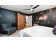 Bedroom with floral wall, king-size bed, and wood cabinet at 5956 Nyberg Rd, North Port, FL 34291
