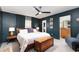 Main bedroom with a king-size bed and dark-blue walls at 5956 Nyberg Rd, North Port, FL 34291