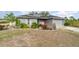 Gray house with solar panels and a landscaped yard at 5956 Nyberg Rd, North Port, FL 34291