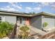 Front view of gray house with orange door and wooden fence at 5956 Nyberg Rd, North Port, FL 34291