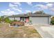 Gray house with solar panels, orange door, and landscaped yard at 5956 Nyberg Rd, North Port, FL 34291