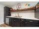 Updated kitchen, featuring dark cabinetry, stainless steel appliances, and a stylish backsplash at 5956 Nyberg Rd, North Port, FL 34291