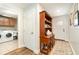 Laundry room with washer, dryer, and wooden cabinets at 5956 Nyberg Rd, North Port, FL 34291