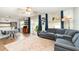 Living room with sectional sofa, wood floors, and large windows at 5956 Nyberg Rd, North Port, FL 34291