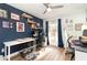 Home office with two work stations, plenty of natural light, and dark blue walls at 5956 Nyberg Rd, North Port, FL 34291