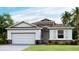 Single-story home with stone accents and a two-car garage at 6758 Broad River Ave, Land O Lakes, FL 34638