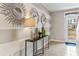 Bright entryway with a console table, mirrors, and a striped accent wall at 7041 Broad River Ave, Land O Lakes, FL 34638