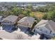 Aerial image showing three tan townhouses with attached garages at 7626 Red Mill Cir, New Port Richey, FL 34653