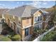 Rear view of tan townhouse, gray roof and fenced yard at 7626 Red Mill Cir, New Port Richey, FL 34653