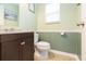 Clean bathroom with a dark brown vanity and green wall accents at 9024 White Sage Loop # 37, Lakewood Ranch, FL 34202