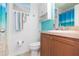 Bathroom with wood cabinets and a teal accent wall at 9024 White Sage Loop # 37, Lakewood Ranch, FL 34202