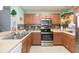 Modern kitchen featuring stainless steel appliances and ample counter space at 9024 White Sage Loop # 37, Lakewood Ranch, FL 34202