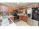 Well-equipped kitchen with stainless steel appliances and wood cabinets at 9024 White Sage Loop # 37, Lakewood Ranch, FL 34202