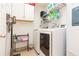 Laundry room with washer, dryer, and ample storage at 9024 White Sage Loop # 37, Lakewood Ranch, FL 34202