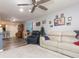 Spacious living room with comfortable seating, a decorative tree, and an open floor plan at 9024 White Sage Loop # 37, Lakewood Ranch, FL 34202