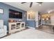 Open concept living room with a media console and partial kitchen view at 9024 White Sage Loop # 37, Lakewood Ranch, FL 34202