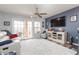 Living room featuring a neutral color scheme, a large TV, and access to a balcony at 9024 White Sage Loop # 37, Lakewood Ranch, FL 34202