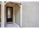 Front entrance with black door and welcome mat at 11728 Cambium Crown Dr, Riverview, FL 33569