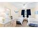 Two twin beds, dresser, and ceiling fan in a bright bedroom at 20040 Gulf Blvd # 605, Indian Shores, FL 33785