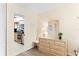 Bedroom with dresser, mirror and view into kitchen at 20040 Gulf Blvd # 605, Indian Shores, FL 33785