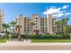 Sand Castle III building exterior, featuring a modern design and lush landscaping at 20040 Gulf Blvd # 605, Indian Shores, FL 33785