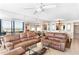 Living room with brown sofas and ocean view at 20040 Gulf Blvd # 605, Indian Shores, FL 33785