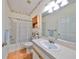 Clean bathroom with shower/tub combo, vanity, and linen cabinet at 2620 Newcomb Ct, Sun City Center, FL 33573