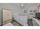 Bedroom with a floral comforter, dresser, and double door closet at 2620 Newcomb Ct, Sun City Center, FL 33573