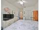 Bright bedroom with a floral comforter, dresser, and large closet at 2620 Newcomb Ct, Sun City Center, FL 33573
