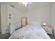 Bedroom with a floral comforter, dresser, and double door closet at 2620 Newcomb Ct, Sun City Center, FL 33573