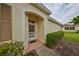 Inviting entryway with a brown door and well-maintained landscaping at 2620 Newcomb Ct, Sun City Center, FL 33573