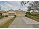 Two-car garage and front yard with landscaping at 2620 Newcomb Ct, Sun City Center, FL 33573