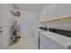 Laundry room with washer, dryer, and storage shelves at 2620 Newcomb Ct, Sun City Center, FL 33573