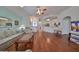 Bright living room with hardwood floors and views into the kitchen at 2620 Newcomb Ct, Sun City Center, FL 33573
