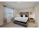 Bright bedroom featuring a comfortable bed and large window at 2920 Evergreen Elm Pass, Wesley Chapel, FL 33543