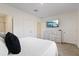 Main bedroom with dresser and large TV mounted on the wall at 2920 Evergreen Elm Pass, Wesley Chapel, FL 33543